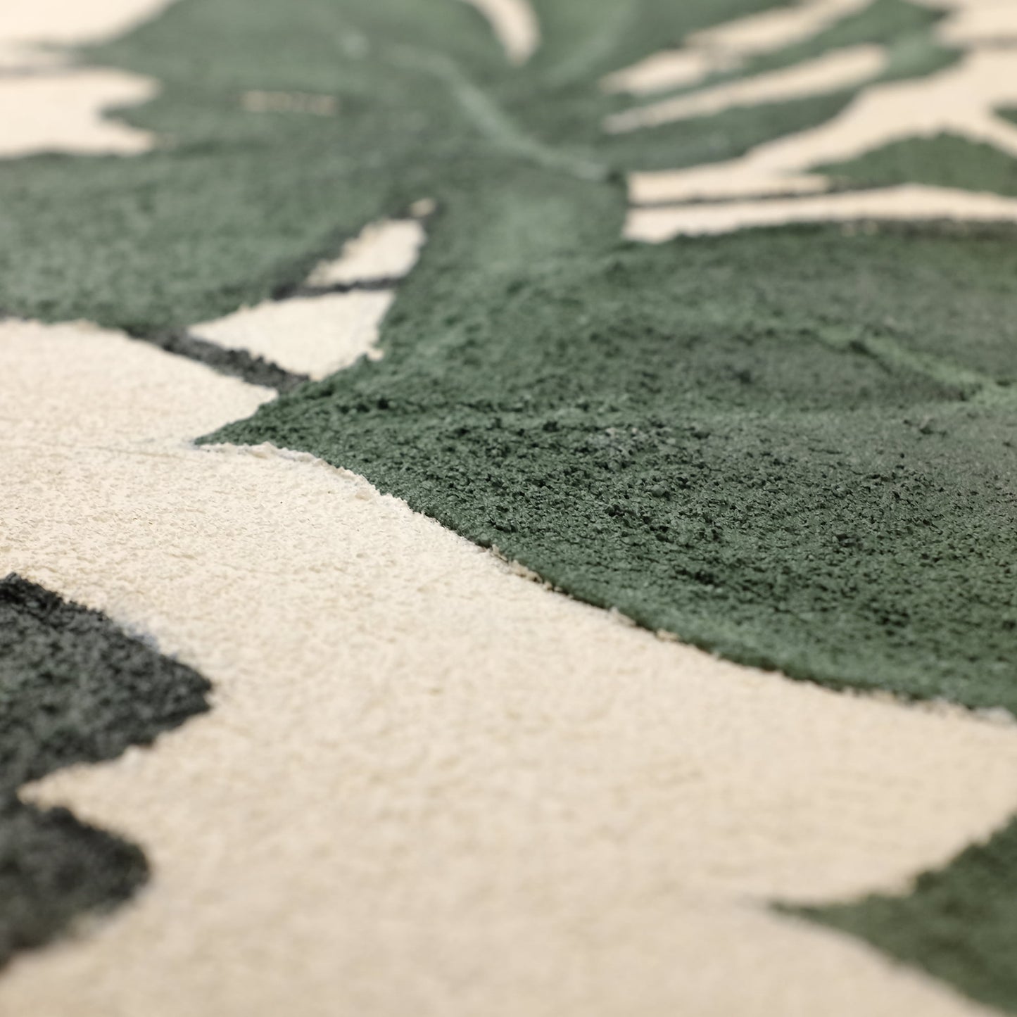 "Close-up details of textured painting named MONSTERA DELICIOSA"