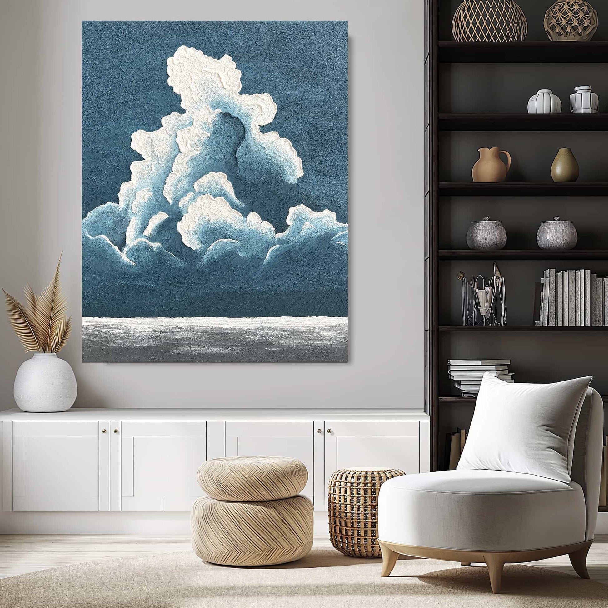 "BILLOWY CLOUDS: Hand-painted Portrait shaped abstract textured wall art painting depicting a large cloud in the sky, with a blue and white colour palette, hanging in lounge."