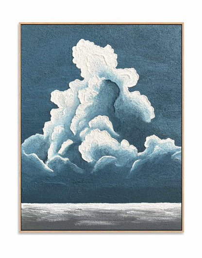 "BILLOWY CLOUDS: Hand-painted Portrait shaped abstract textured wall art painting depicting a large cloud in the sky, with a blue and white colour palette, framed in a oak shadow box."