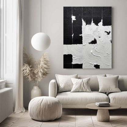 "Hand-painted abstract textured wall art titled 'MIDNIGHT TRACINGS.' This evocative artwork, suitable for portrait orientation, depicts the theme of footprints in a snowy night. The composition is rich in texture, predominantly featuring a black and white colour palette, hanging in the living room."