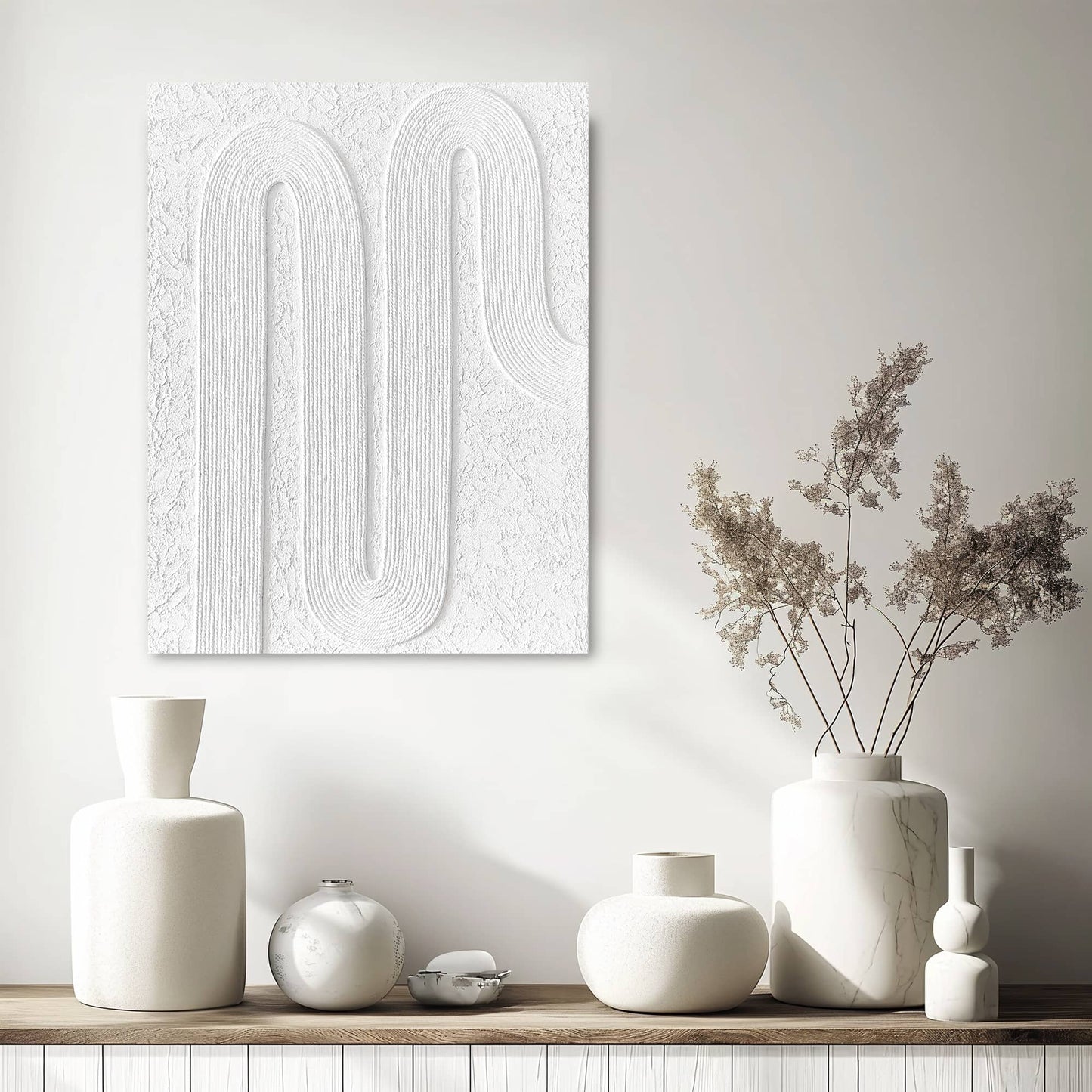 "Hand-painted Portrait shaped abstract textured wall art named 'Serenity Threads,' featuring white threads arranged in regular curves, hanging in the hallway."