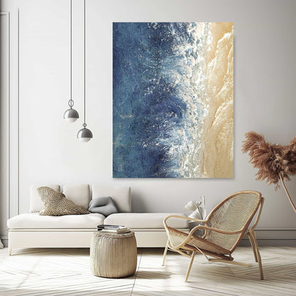 "Hand-painted, textured wall art depicting waves and sandy shores. Titled 'THE SEASHORE, STYLE C,' this portrait-shaped artwork in shades of blue and cream is elegantly hung in the lounge."