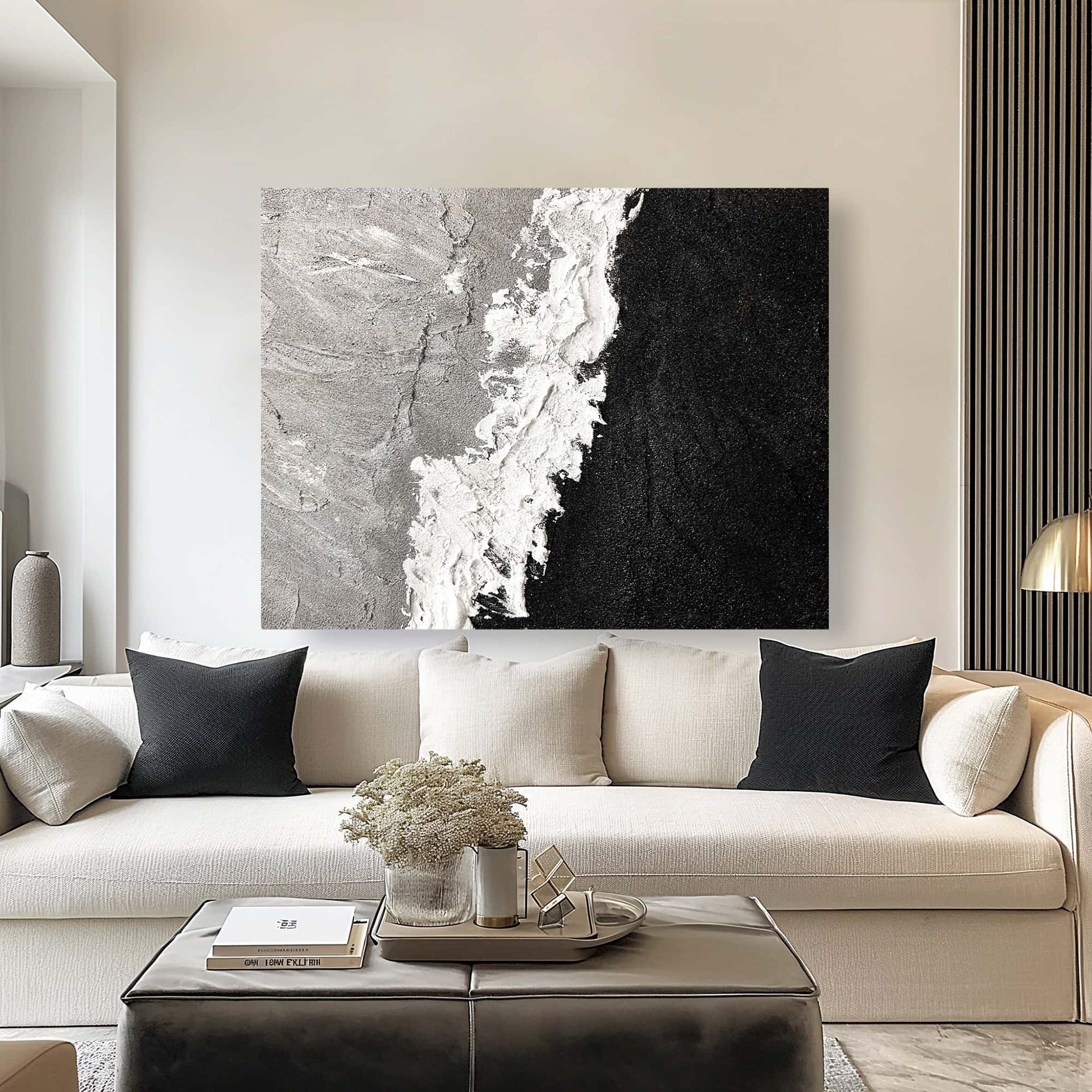 "Hand-painted Landscape shaped abstract textured wall art named 'Untamed Rift.' The artwork features a grey and black background separated by wild and expressive white strokes. The painting may symbolize a blend of elements or the conflict between water and fire. Hanging in living room."