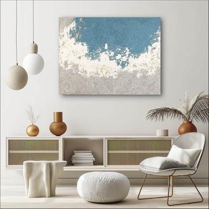 "SILVER BAY: Hand-painted Landscape shaped abstract textured wall art painting depicting an abstract bay, full of texture, in shades of blue, white, grey, and gold, hanging on the wall in the lounge."